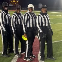 Football officials on the field at night
