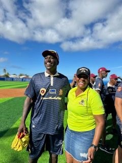 Natola Hawthorne with a baseball player at the field